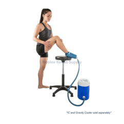User seated with Aircast ankle cryo cuff connected to portable cooler system for continuous cold therapy and rehabilitation treatment.