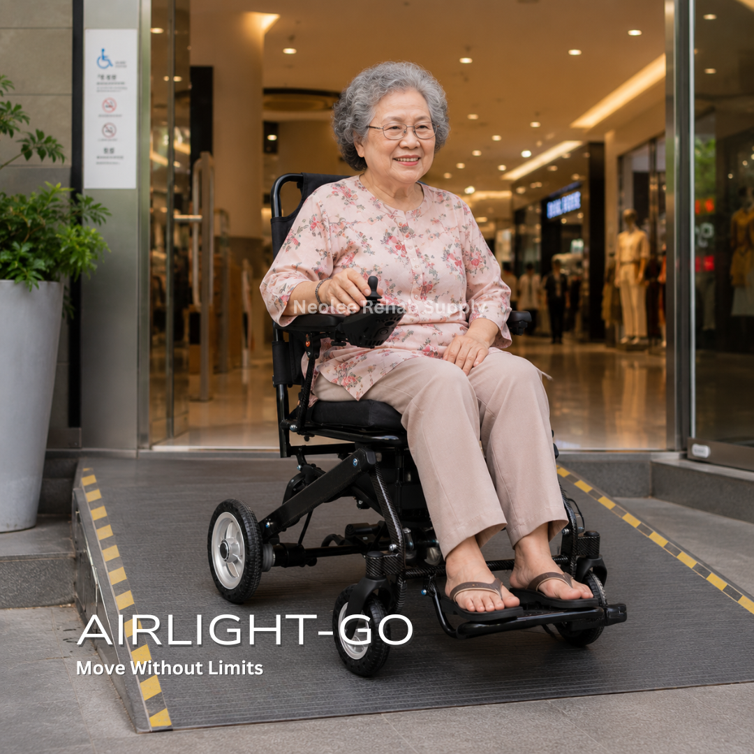 Elderly woman using the Airlight-GO Aluminium Electric Wheelchair at a shopping mall entrance, showcasing compact powered mobility and easy indoor navigation.