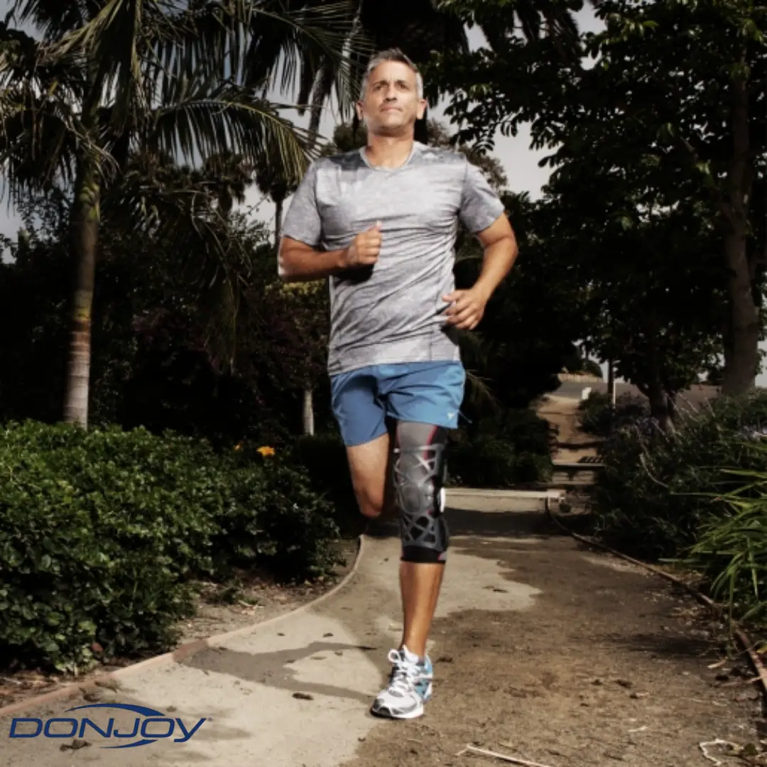 MAN RUNNING WITH DONJOY OA REACTION WEB KNEE BRACE