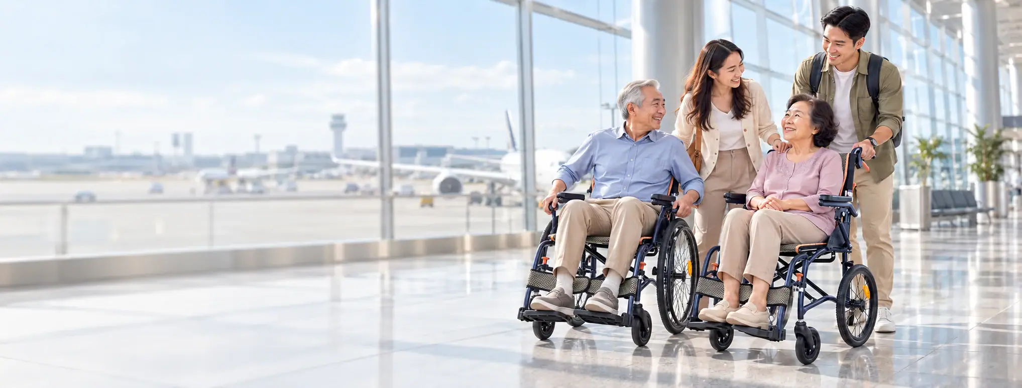 A family travelling together with two older adults in wheelchairs